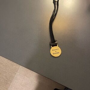 Dooney & Bourke Gold Tone handbag charm hang tag with black leather strap-Nice!